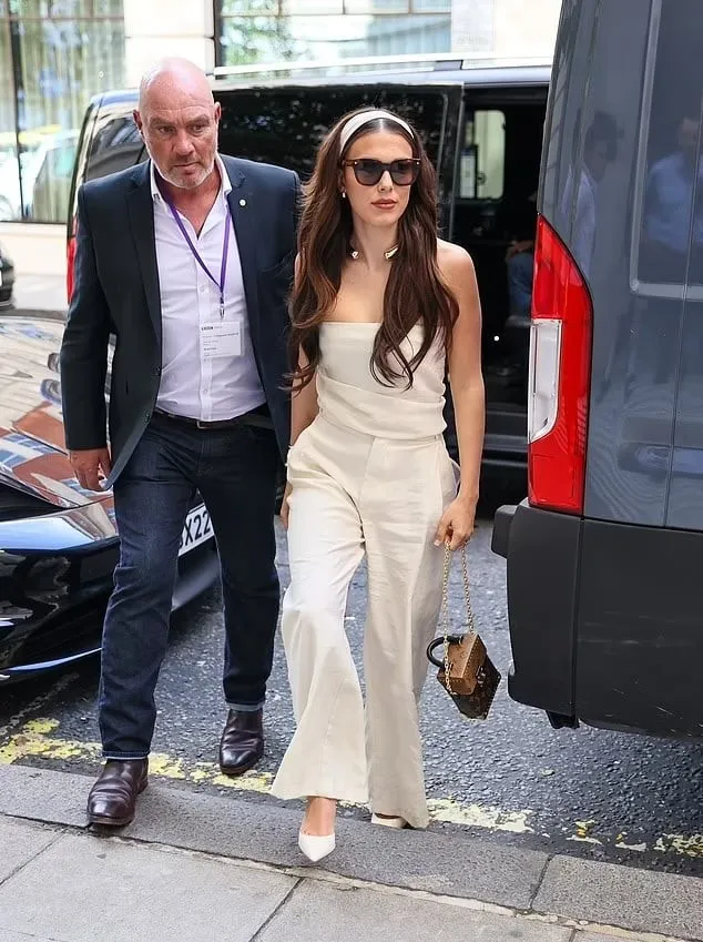A Sectech officer walking beside a client on a London street