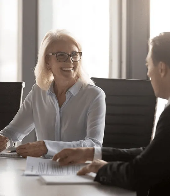 Two advisers talking across a desk